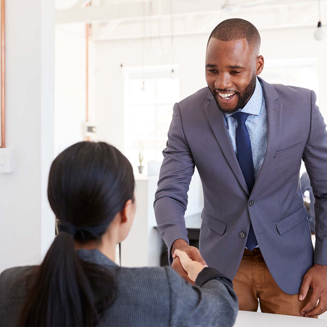 Man shaking womans hand