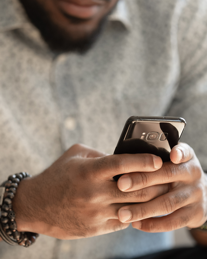 man typing on phone