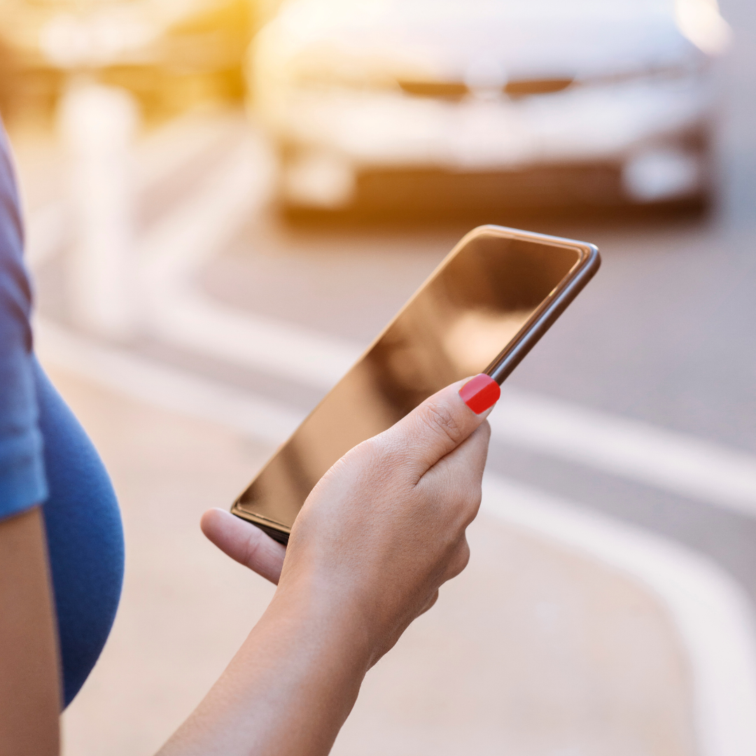 woman contacting rideshare company on mobile phone