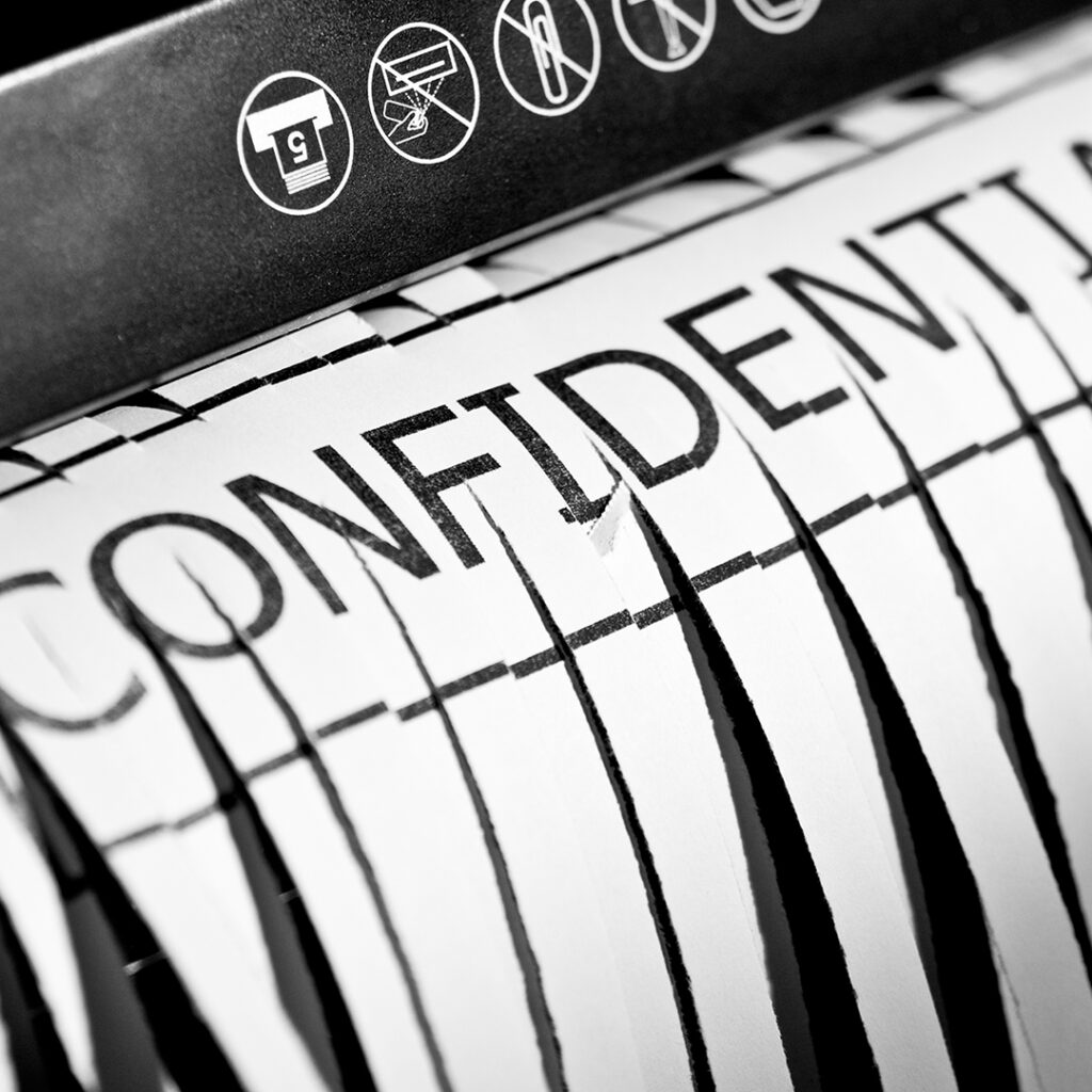 A confidential paper being shredded