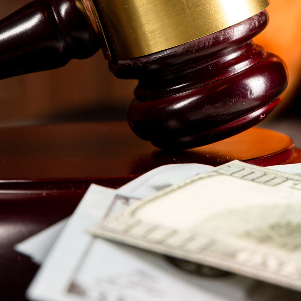 A gavel next to a stack of cash