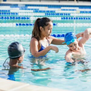 A woman giving swimming lessons.
