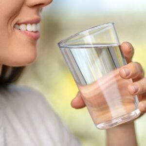 A woman drinking water.