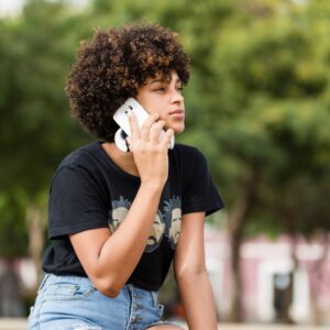 A young woman on the phone with a family member.