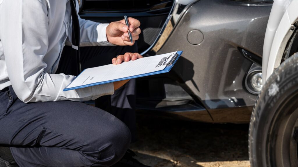 An insurance provider inspecting a vehicle.