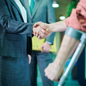 injured person shaking hands with lawyer