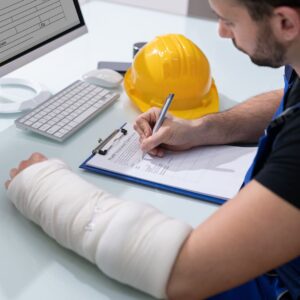 worker with an injury signing document