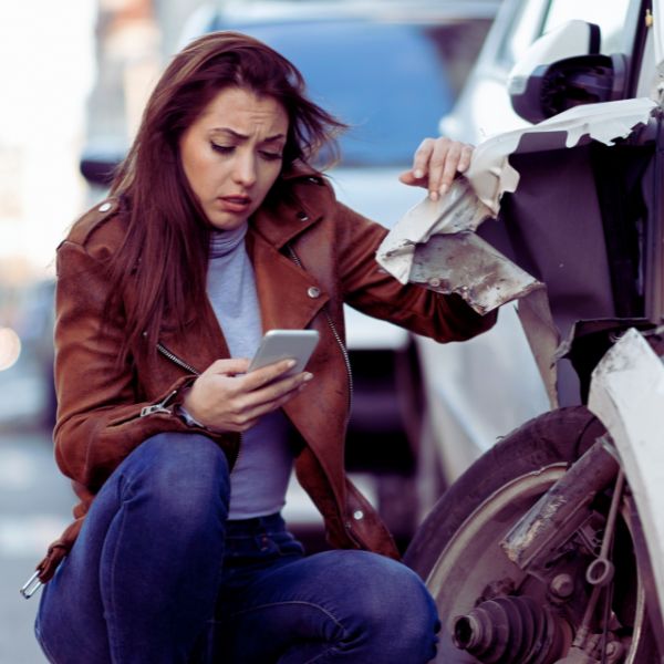 woman on phone at car accident