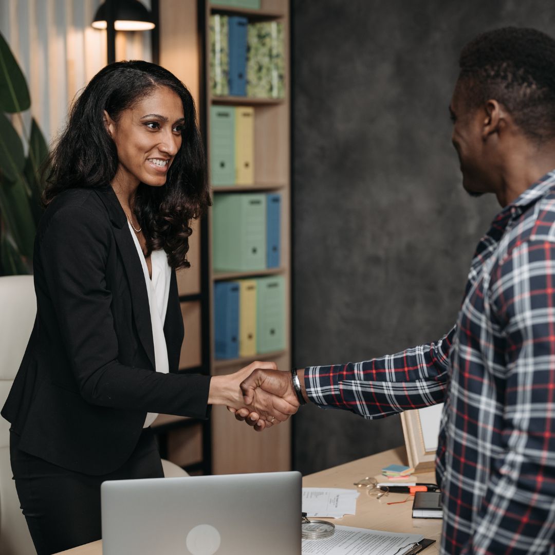 A lawyer shakes hands with a client
