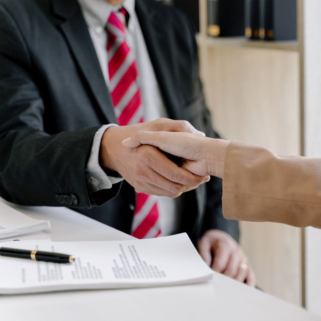 A lawyer shakes hands with a client