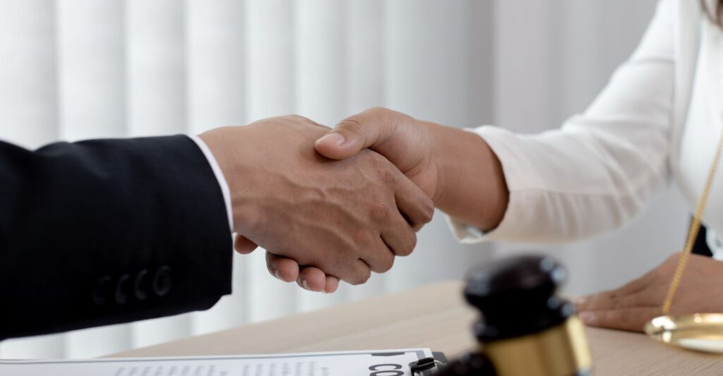 attorney shaking hands with client