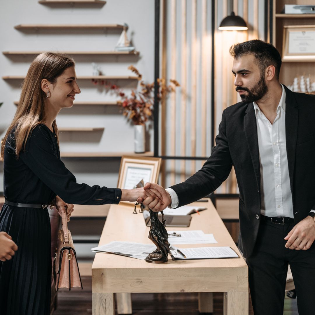 A lawyer shaking hands with a client