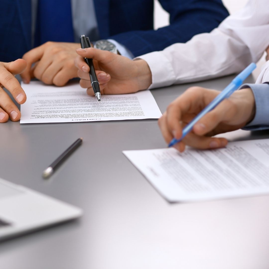 lawyer working with client on signing settlement