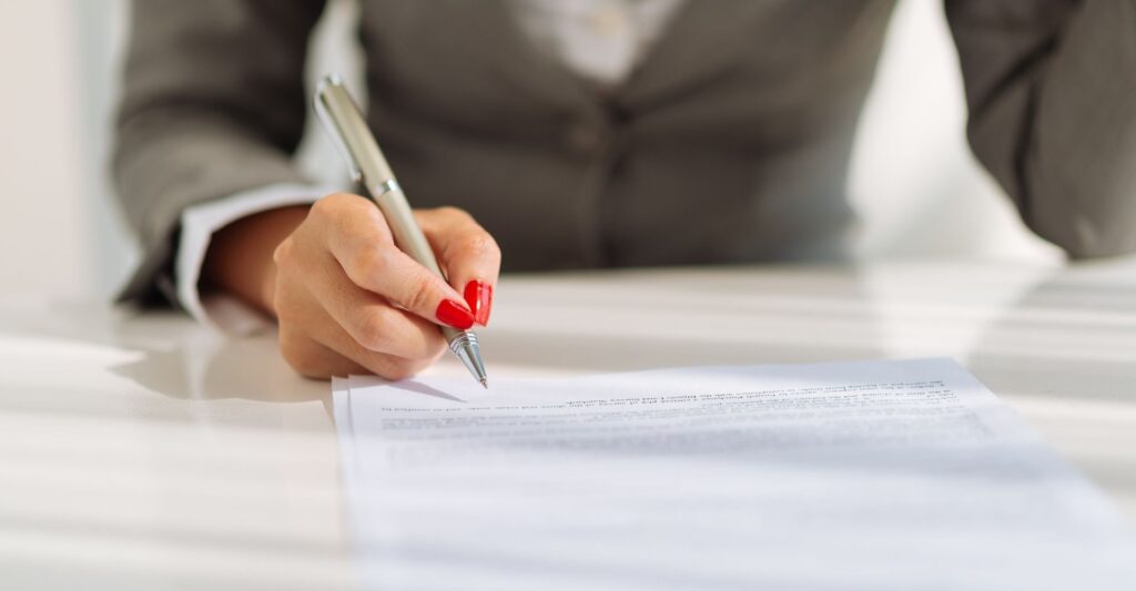 lawyer writing on contract