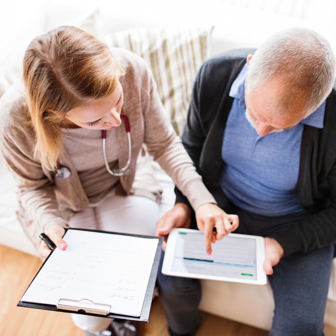 nurse speaking with older man