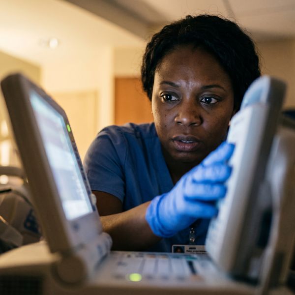 woman looking at hospital monitor