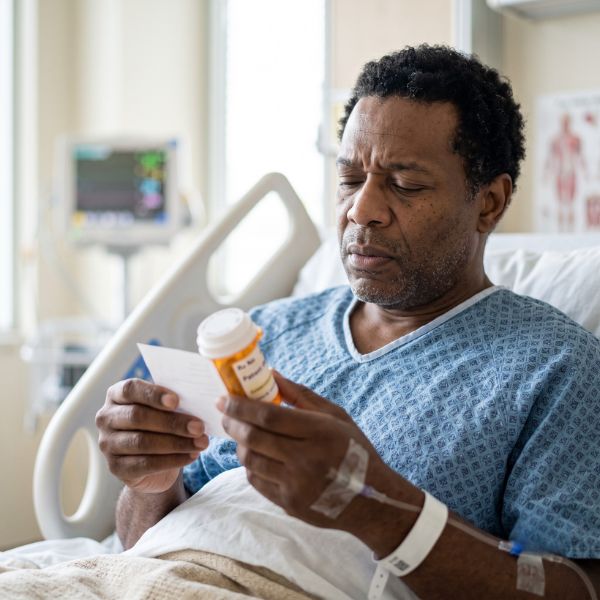 man in hospital with drug box