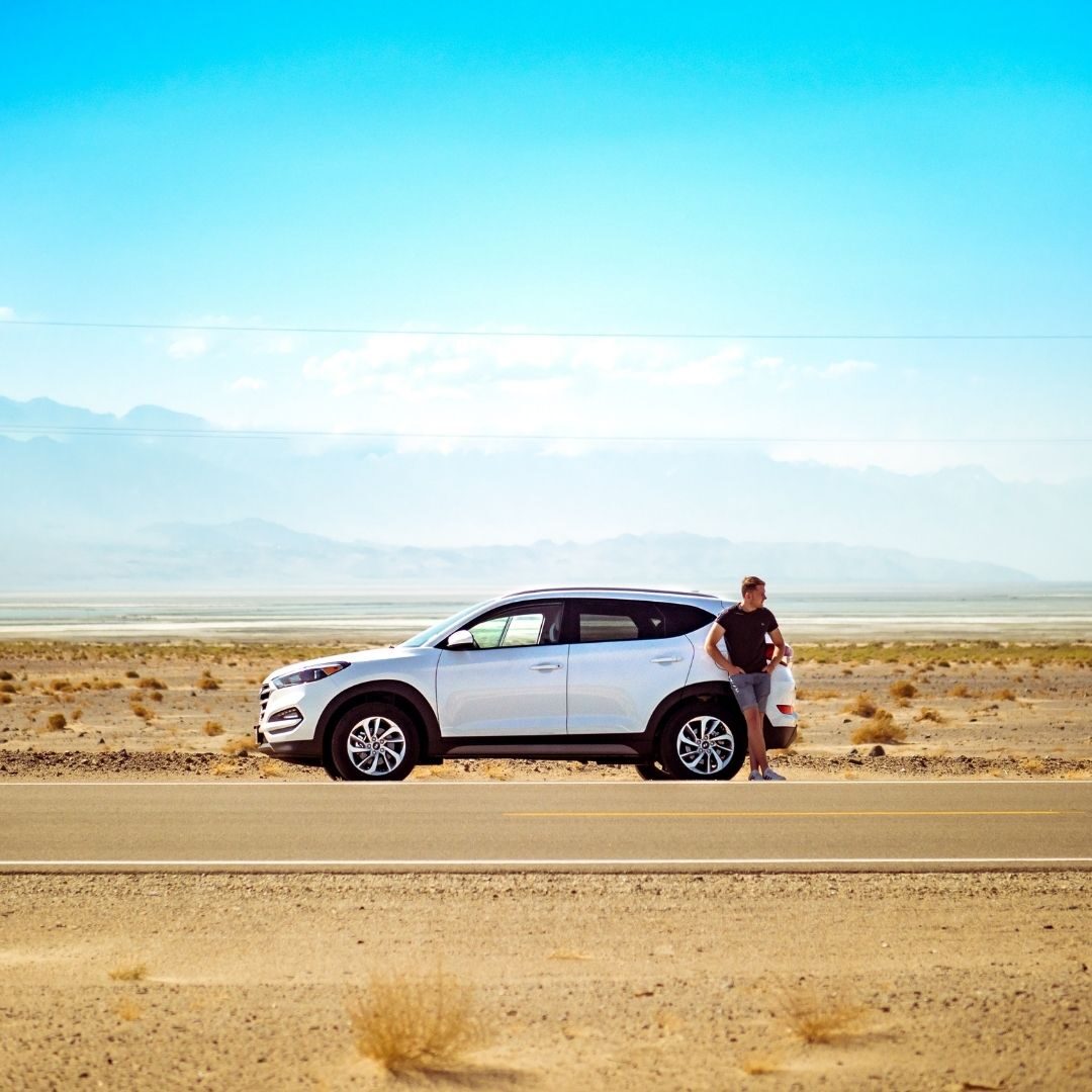 Man standing next to his car
