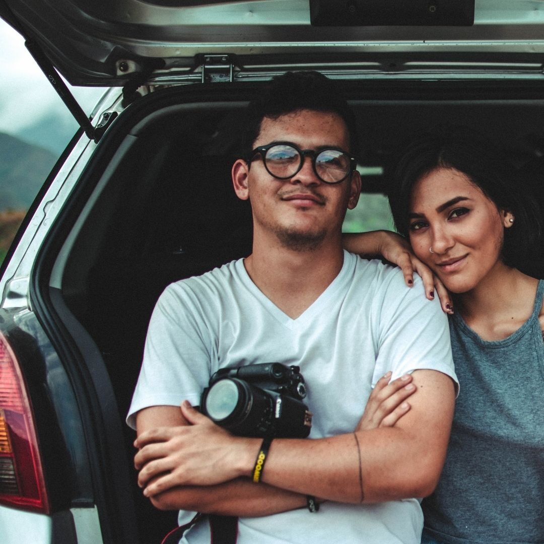 man and women sitting in the car
